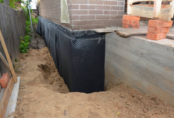 Happy homeowners after waterproofing job in Troy
